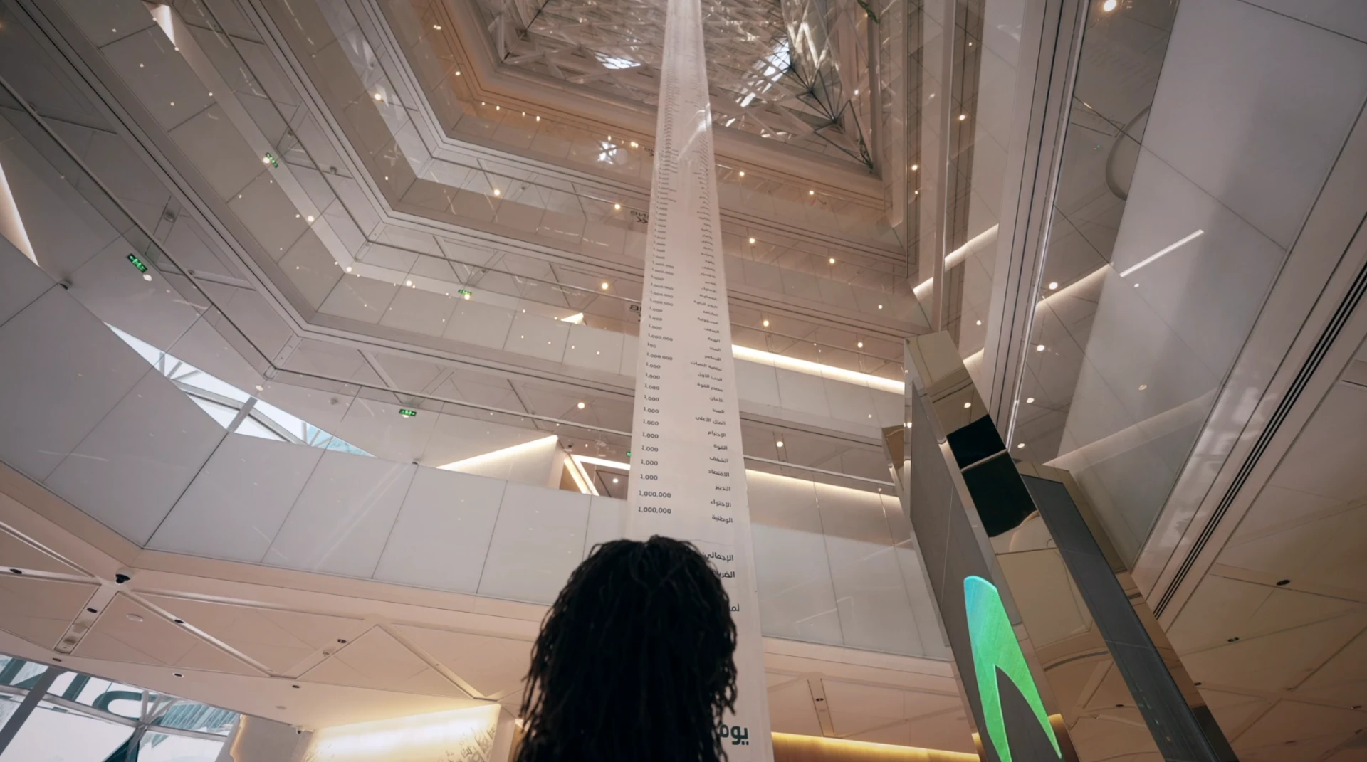 SNB Life Long Receipt installation , a towering printed receipt running through a bright modern atrium