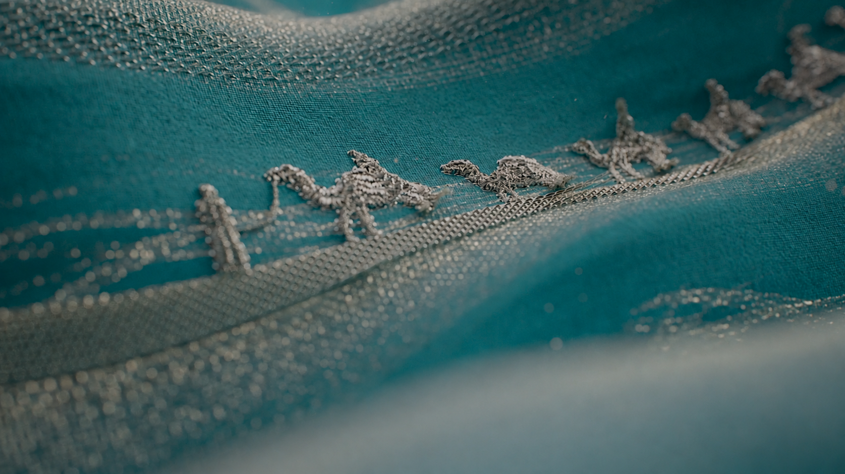 One Thread at a Time , a horse and rider woven from Sadu thread on deep teal