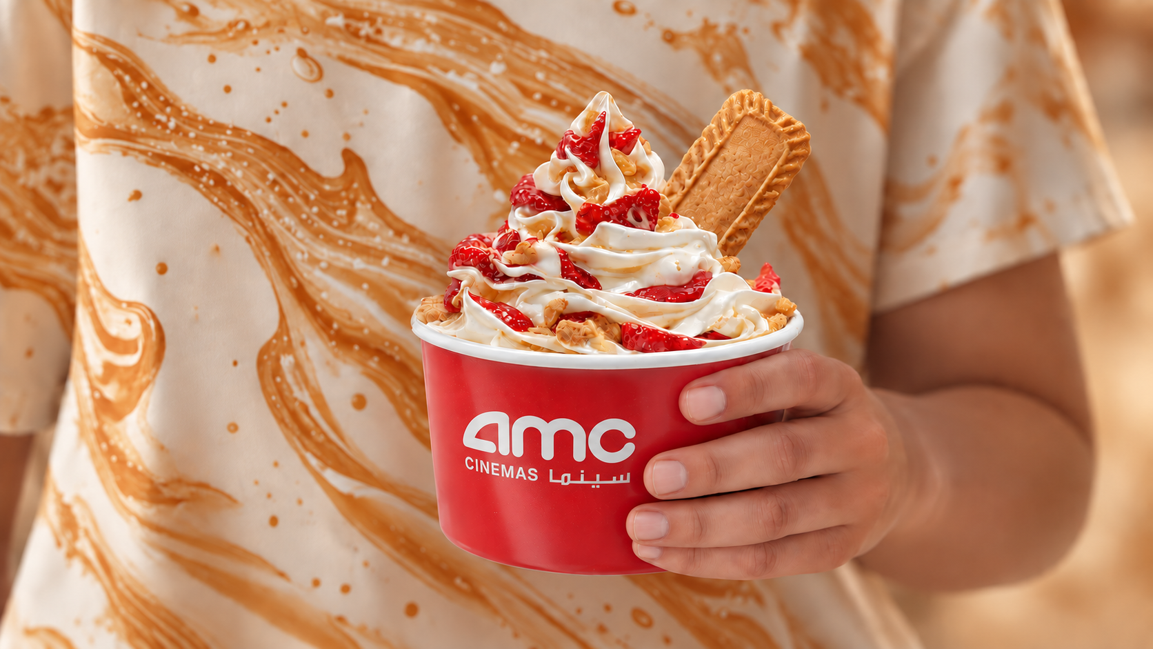 AMC Cinemas branded ice cream cup held in hand