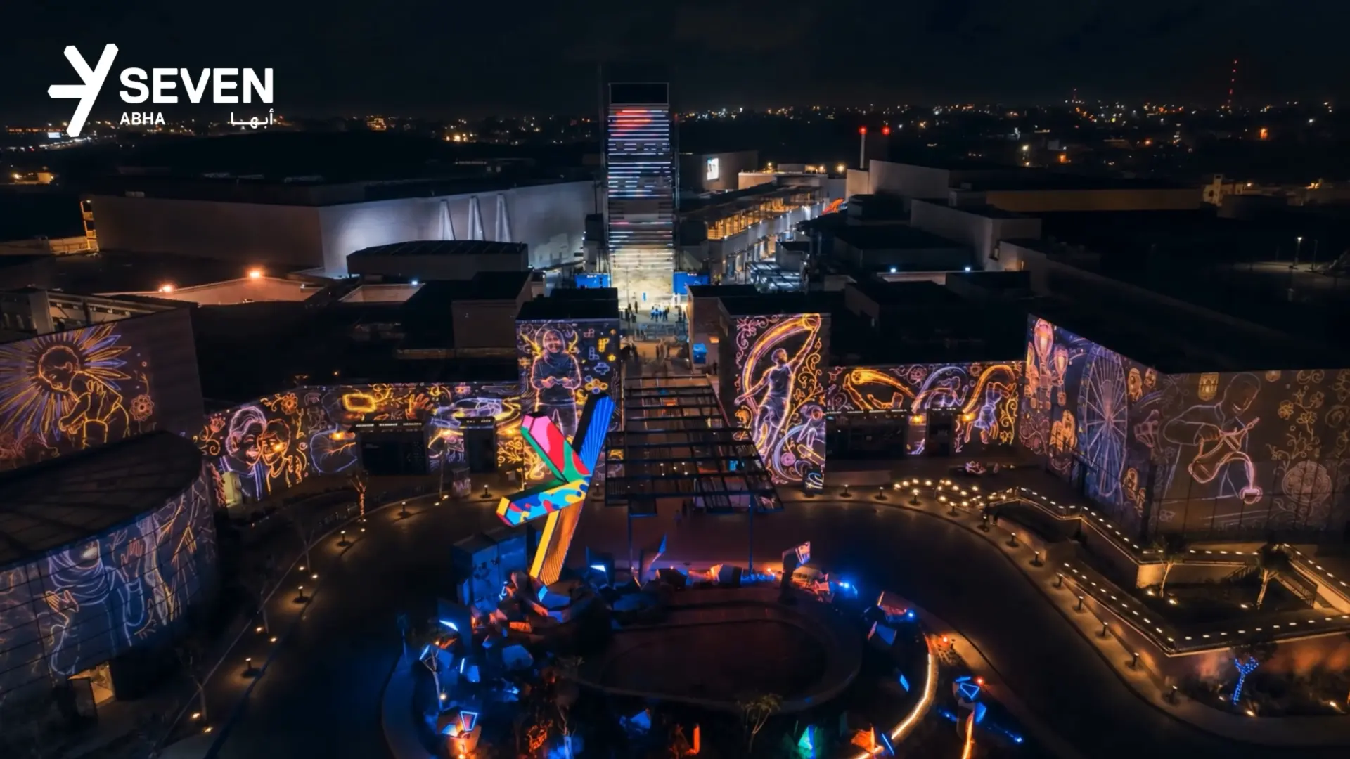 SEVEN Abha opening night , neon illustrated projection mapping across the plaza